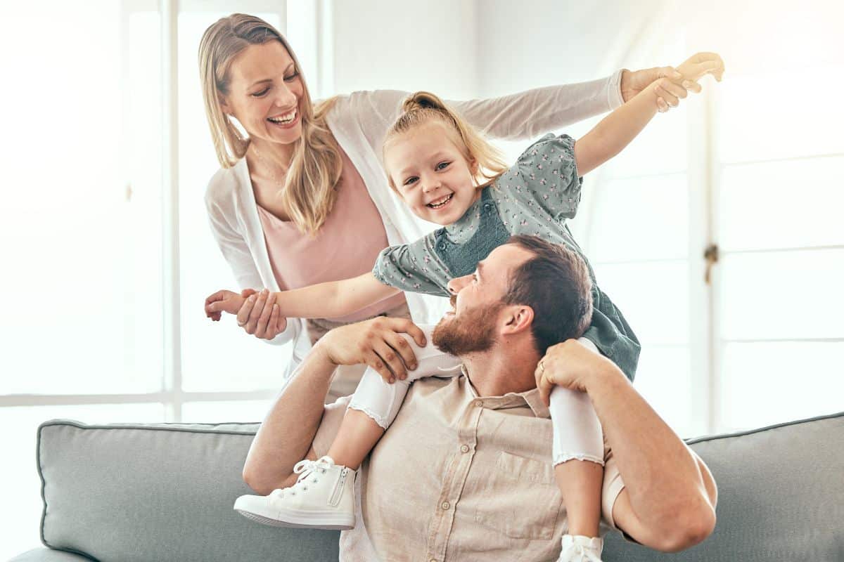 Happy family on couch smiling applause and patient testimonials