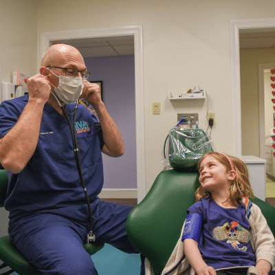 Celebrate national children’s dental health month: healthy dental habits for kids 4 Dr. Justin edwards prepares to do a dental assessment on a little kid, representing healthy dental habits for kids