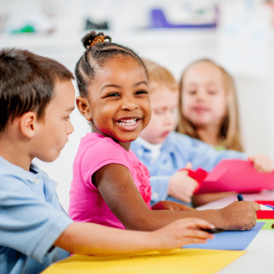 Children engaged in creative activities together, representing saliva and oral health